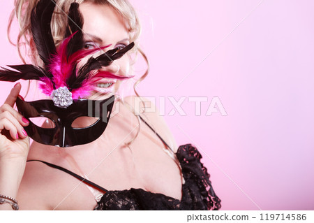 Woman middle aged holds carnival mask. Woman middle aged holds carnival mask. 119714586