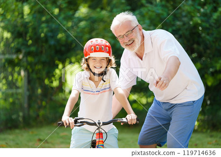 Grandfather and kids in sunny garden Grandfather and kids in sunny garden 119714636
