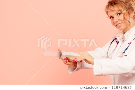 Nurse with big syringe. 119714685