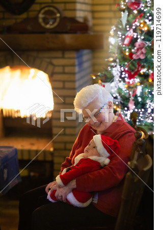 Family with kids having Christmas dinner at tree Family with kids having Christmas dinner at tree 119714699