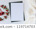 Blank Christmas Card with Holly Wreath and Knit Fabric for Festive and Winter Holiday Designs. Christmas mockup 119714703