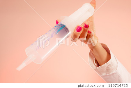 Woman hand with syringe. Woman hand with syringe. 119714725