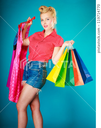 Pinup girl with shopping bags buying dress. Sale Pinup girl with shopping bags buying dress. Sale 119714770