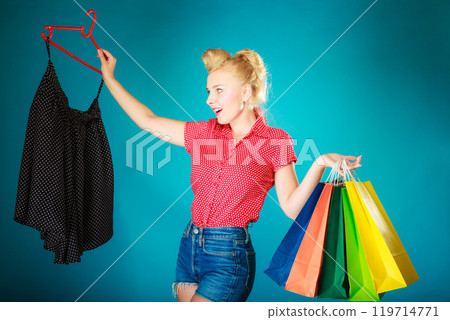 Pinup girl buying clothes black skirt. Sale retail Pinup girl buying clothes black skirt. Sale retail 119714771
