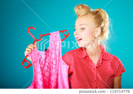 Pinup girl buying clothes pink dress. Sale retail. Pinup girl buying clothes pink dress. Sale retail. 119714776