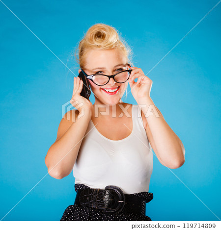 Pin up retro gril with glasses and phone. 119714809