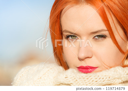Beauty face red hair woman in warm clothing outdoor 119714879