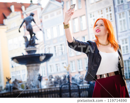 woman taking self picture with smartphone camera woman taking self picture with smartphone camera 119714890