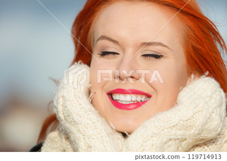 Beauty face red hair woman in warm clothing outdoor 119714913
