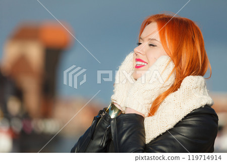 Beauty red hair woman in warm clothing outdoor Beauty red hair woman in warm clothing outdoor 119714914