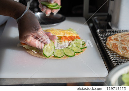 Chef prepares flatbread with salmon. Quesadilla. Chef prepares flatbread with salmon. Quesadilla. 119715255