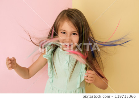 A beautiful girl with colored strands of floating hair. Safe hair coloring, bright saturated color. 119715366
