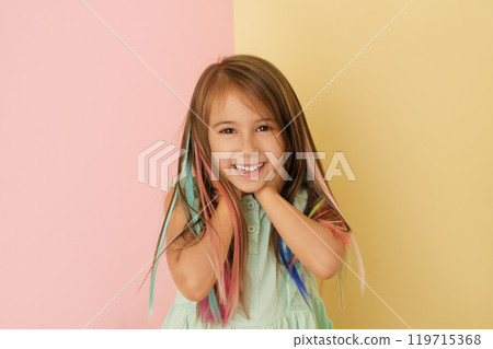 Laughing happy beautiful girl with colorful bright locks of hair. Laughing happy beautiful girl with colorful bright locks of hair. 119715368