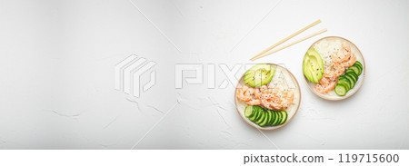 Two white ceramic bowls with rice, shrimps, avocado, vegetables and sesame seeds and wooden sticks on white concrete stone background top view. Healthy asian style poke bowl, space for text Two white ceramic bowls with rice, shrimps, avocado, vegetables and sesame seeds and wooden sticks on white concrete stone background top view. Healthy asian style poke bowl, space for text 119715600