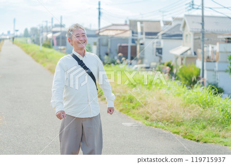 Elderly man taking a walk 119715937