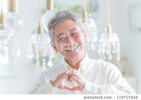 Smiling senior man making a heart symbol with his hands (love/marriage hunting) 119715938