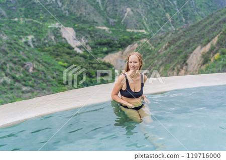 Female tourist at the hot springs of Grutas Tolantongo, Mexico. Adventure, relaxation, and natural wellness concept Female tourist at the hot springs of Grutas Tolantongo, Mexico. Adventure, relaxation, and natural wellness concept 119716000
