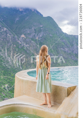 Female tourist at the hot springs of Grutas Tolantongo, Mexico. Adventure, relaxation, and natural wellness concept Female tourist at the hot springs of Grutas Tolantongo, Mexico. Adventure, relaxation, and natural wellness concept 119716004