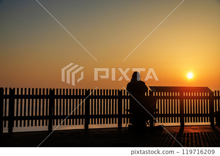 A person taking a photo of the sun rising over a sea of clouds from Takataniyama Observatory in Miyoshi City 119716209