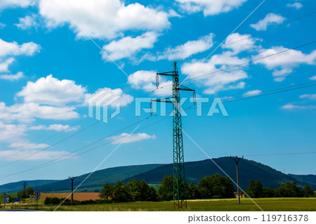 Electric pole power lines outgoing electric wires againts on cloud blue sky. Electric pole power lines outgoing electric wires againts on cloud blue sky. 119716378