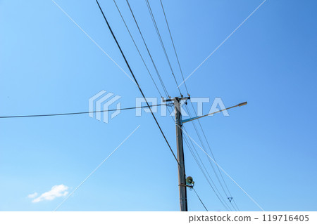 Electric pole power lines outgoing electric wires againts on cloud blue sky. Electric pole power lines outgoing electric wires againts on cloud blue sky. 119716405