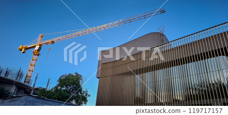 A large crane towers over the construction site. Urbanization. Construction sites everywhere are building up the coast of Odessa, thereby destroying the public and park area. A large crane towers over the construction site. Urbanization. Construction sites everywhere are building up the coast of Odessa, thereby destroying the public and park area. 119717157