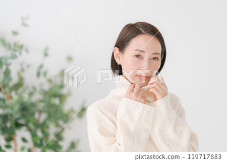 Woman wearing a white turtleneck sweater Woman wearing a white turtleneck sweater 119717883