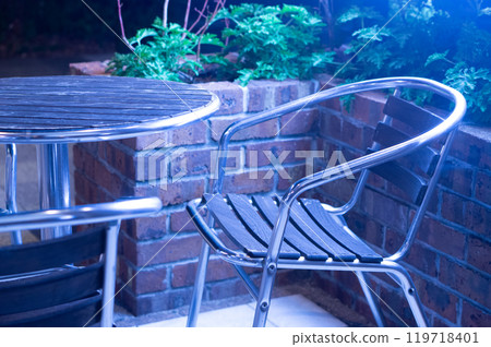 Tables and chairs on cafe terrace at night 119718401