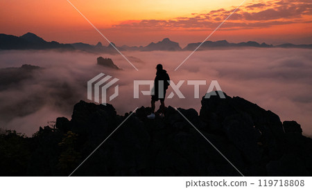 Man standing on the mountain and sea view with mountains in the early morning 119718808