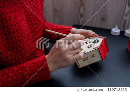 Process of preparing for Christmas and New Year eve. 3D craft wooden houses DIY. Responsible ecological zero waste handmade decoration. Children hobby activity 119718853