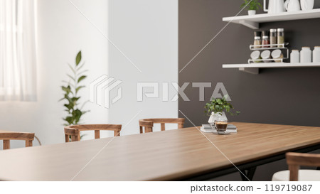 A close-up of a space for displaying products on a wooden dining table in a contemporary white room. 119719087