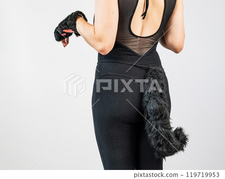 A woman in a cat costume stands with her back showing her tail. Quadrober. A woman in a cat costume stands with her back showing her tail. Quadrober. 119719953