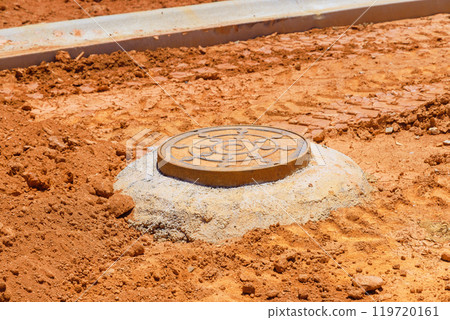 Concrete is being applied to secure blocks forming top edge of an manhole for utility underground infrastructure pit Concrete is being applied to secure blocks forming top edge of an manhole for utility underground infrastructure pit 119720161