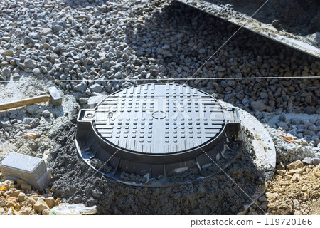 Concrete is being placed to secure forming top border of manhole for utility pit 119720166