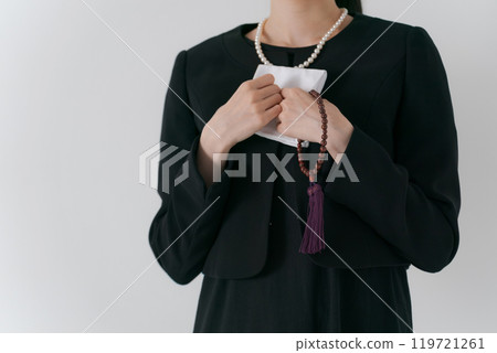 The hands of a woman in mourning clothes holding a handkerchief The hands of a woman in mourning clothes holding a handkerchief 119721261