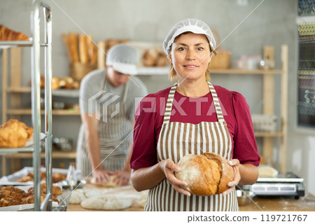 Adult woman baker with homemade bread Adult woman baker with homemade bread 119721767