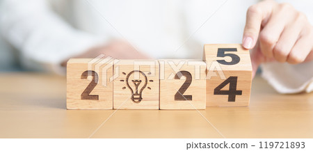 2024 year change to 2025 year block with lightbulb. Business Idea, Creative, Thinking, brainstorm, Goal, Resolution, strategy, plan, Action, change and New Year start concepts 119721893