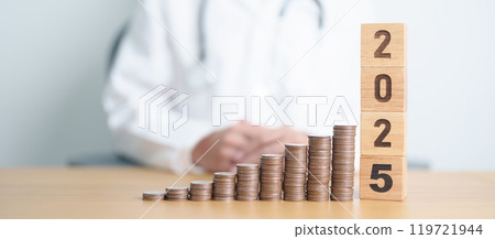 Happy New Year 2025 with Doctor and coins stack. Money stack Counting arrangement for deposit, Healthcare cost, Money Saving, Health Insurance, Medical, Donation and Financial concept 119721944