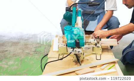 A man cutting wood using an electric saw - DIY A man cutting wood using an electric saw - DIY 119722020