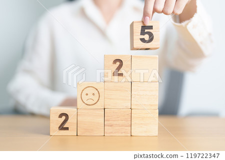 Happy New Year 2025 with Sad face block. Satisfaction, feedback, Review, mental health, eco sustainable and bad year concept 119722347