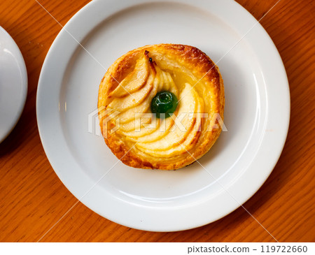 One piece of just prepared apple pie on plate One piece of just prepared apple pie on plate 119722660