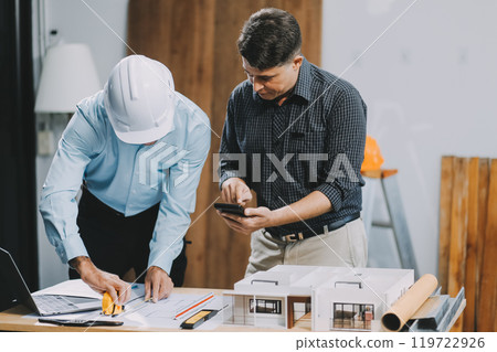 Team Engineers with draft plan of building on constructing site. Engineer work on site. engineer visit and inspection site engineer. Inspector engineer check and working on site. 119722926