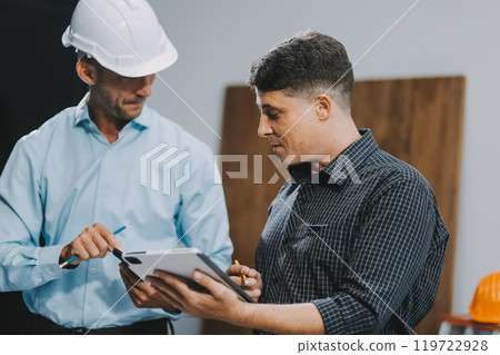 Team Engineers with draft plan of building on constructing site. Engineer work on site. engineer visit and inspection site engineer. Inspector engineer check and working on site. 119722928