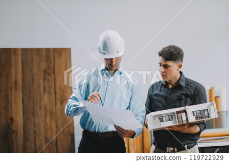 Team Engineers with draft plan of building on constructing site. Engineer work on site. engineer visit and inspection site engineer. Inspector engineer check and working on site. 119722929