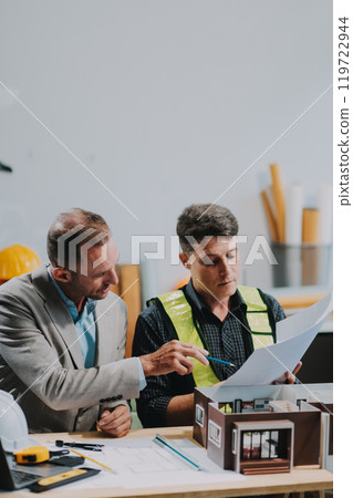 Team Engineers with draft plan of building on constructing site. Engineer work on site. engineer visit and inspection site engineer. Inspector engineer check and working on site. Team Engineers with draft plan of building on constructing site. Engineer work on site. engineer visit and inspection site engineer. Inspector engineer check and working on site. 119722944