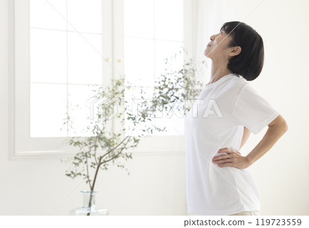 Middle-aged woman doing exercises in the room 119723559