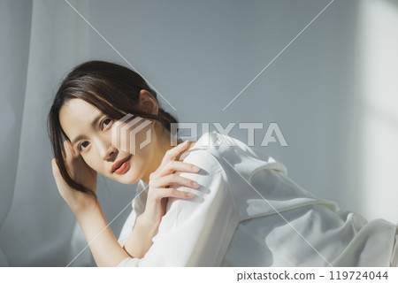 Young woman by the window 119724044