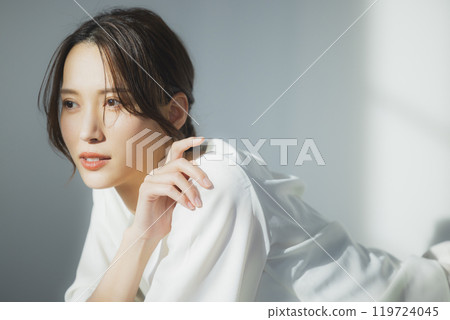 Young woman by the window 119724045