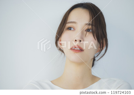 Young woman by the window 119724103