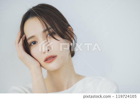 Young woman by the window 119724105